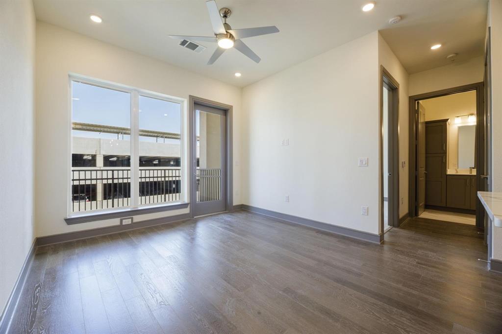 2700 Old Denton Road, Unit 3362 Carrollton, TX 75007 - Photo 3 of 18 an empty room with wooden floor and windows