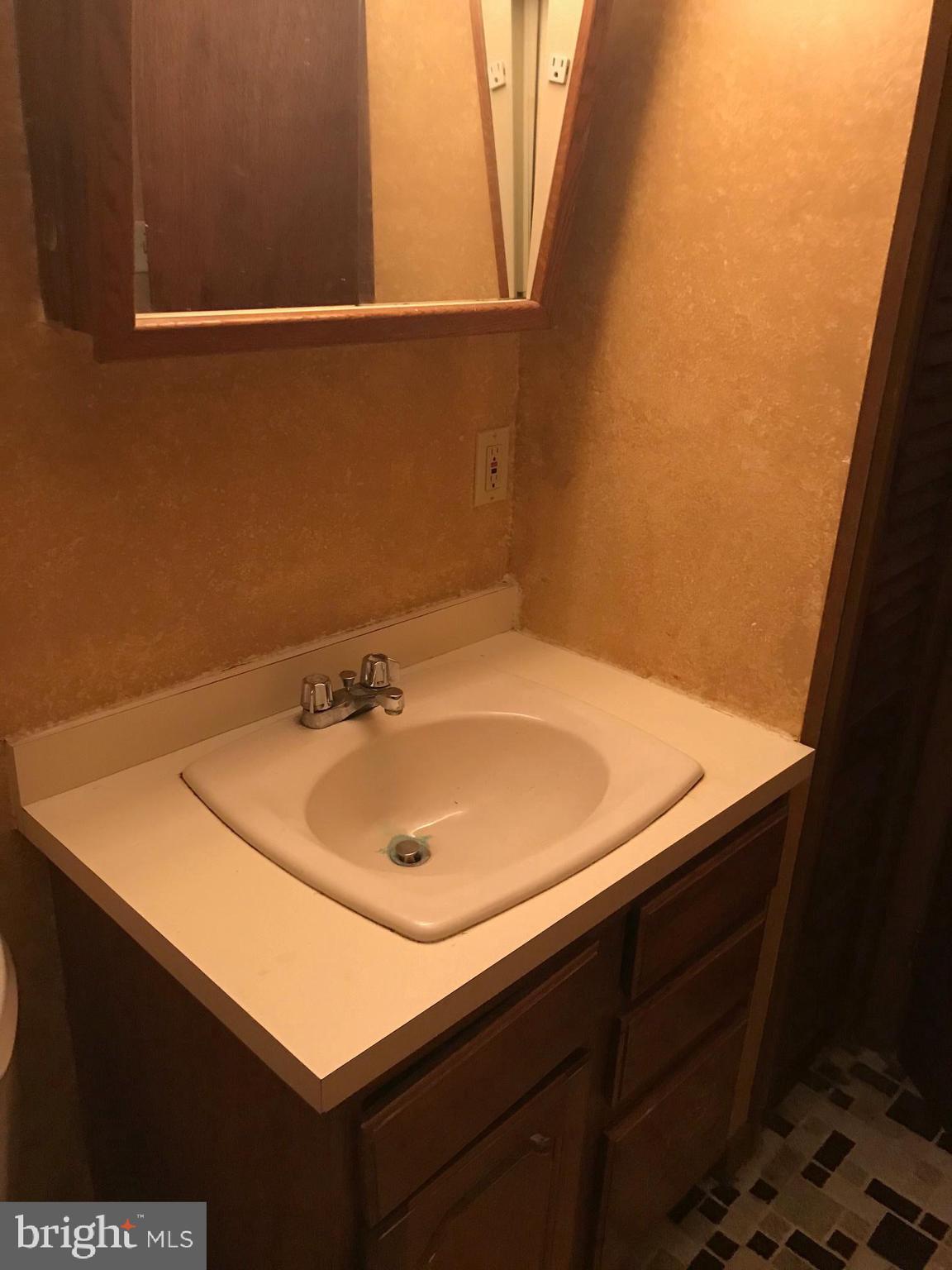 6385 Lake Road Newfield, NJ 08344 - Photo 22 of 36 a bathroom with a sink and a mirror