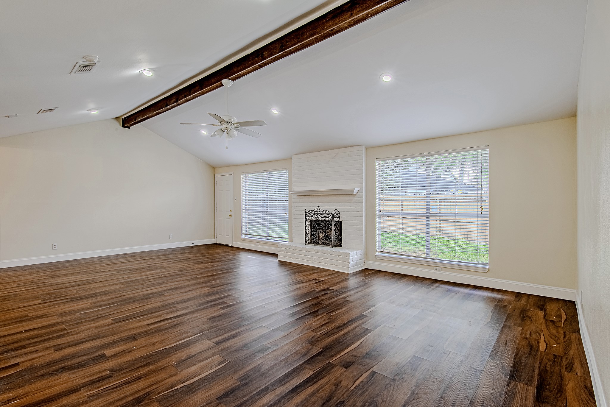 17811 Hawk Haven Lane Spring, TX 77379 - Photo 9 of 22 Comfortable living space with fireplace and large windows overlooking the yard.