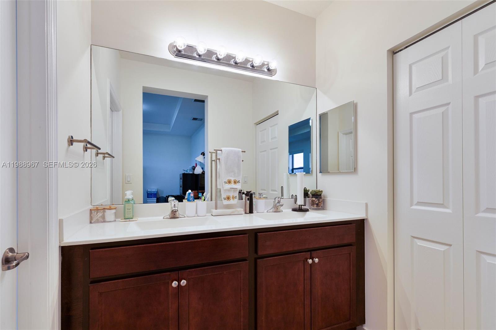 9015 Northwest 183rd Street Hialeah, FL 33018 - Photo 17 of 45 a bathroom with a double vanity sink and mirror