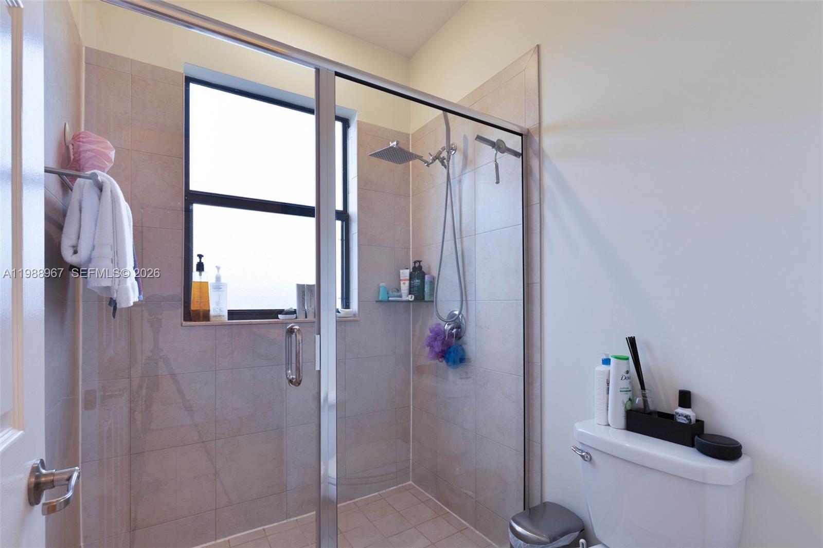 9015 Northwest 183rd Street Hialeah, FL 33018 - Photo 18 of 45 a bathroom with a shower and a toilet