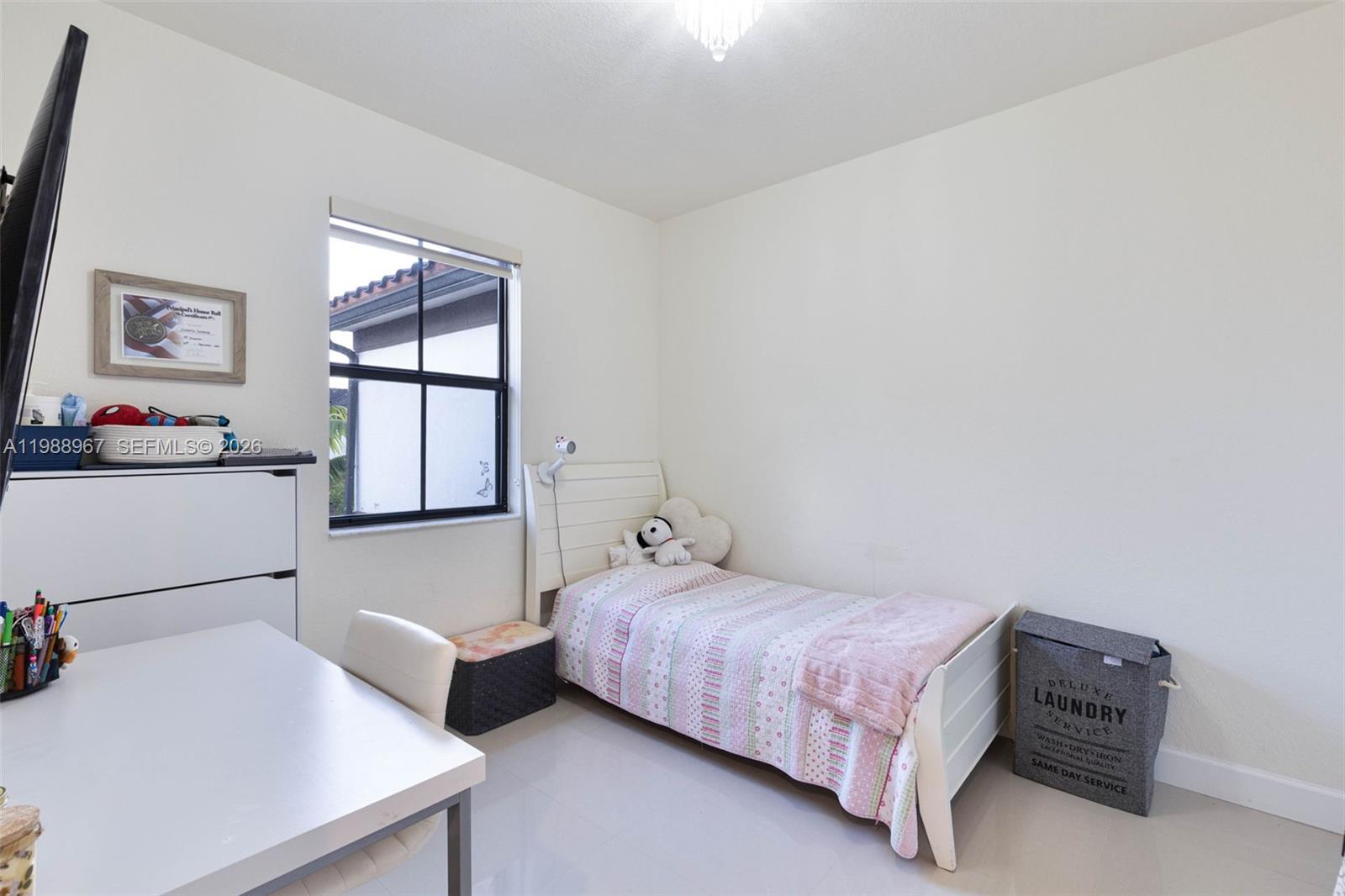 9015 Northwest 183rd Street Hialeah, FL 33018 - Photo 20 of 45 a bedroom with a bed and a dresser