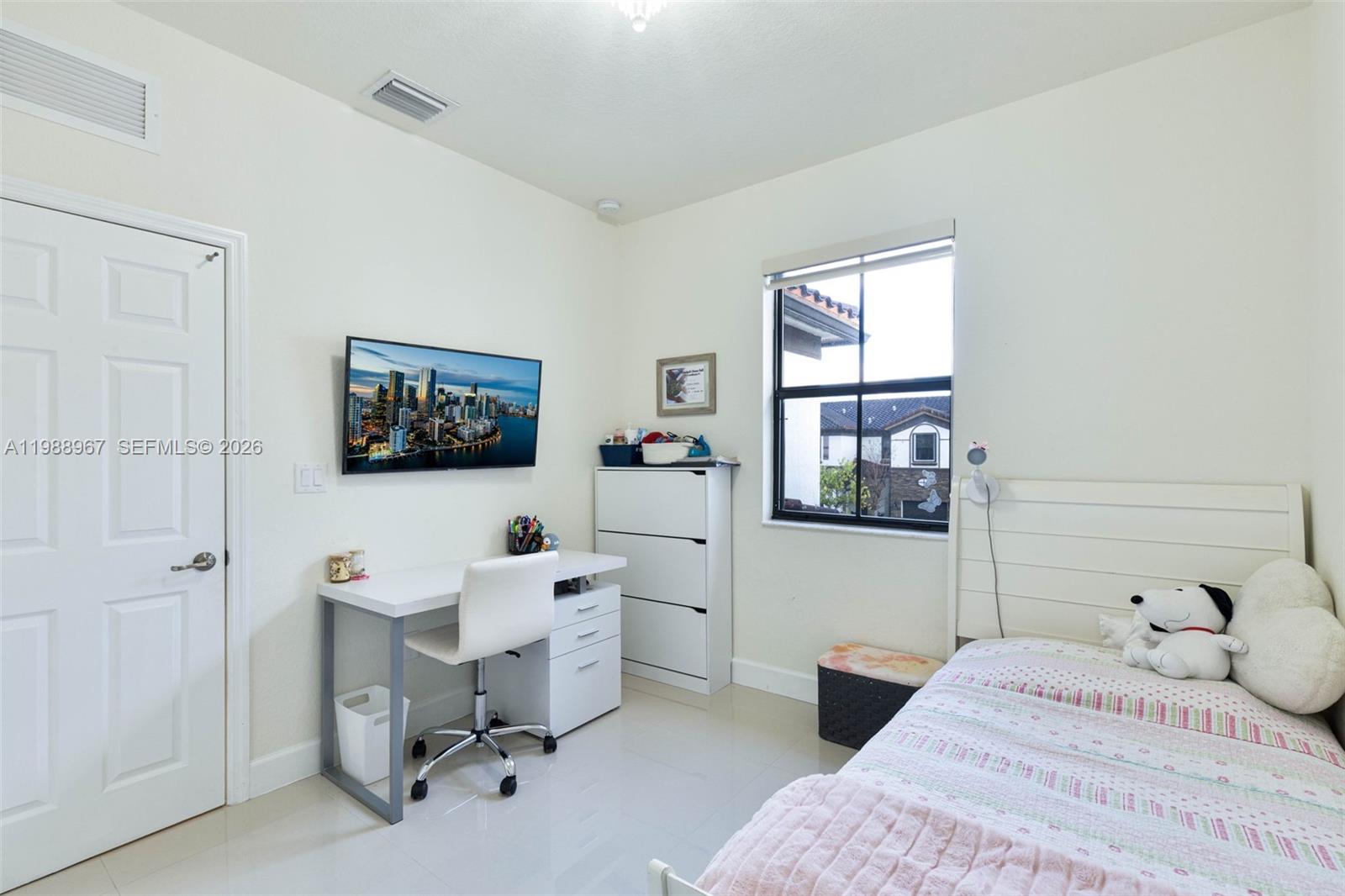 9015 Northwest 183rd Street Hialeah, FL 33018 - Photo 21 of 45 a bedroom with a bed and a window