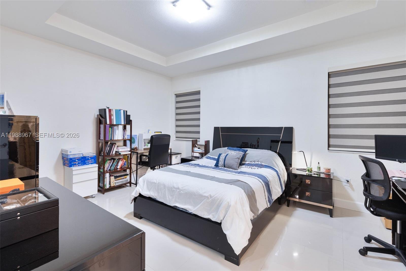 9015 Northwest 183rd Street Hialeah, FL 33018 - Photo 25 of 45 a bedroom with furniture and a flat screen tv