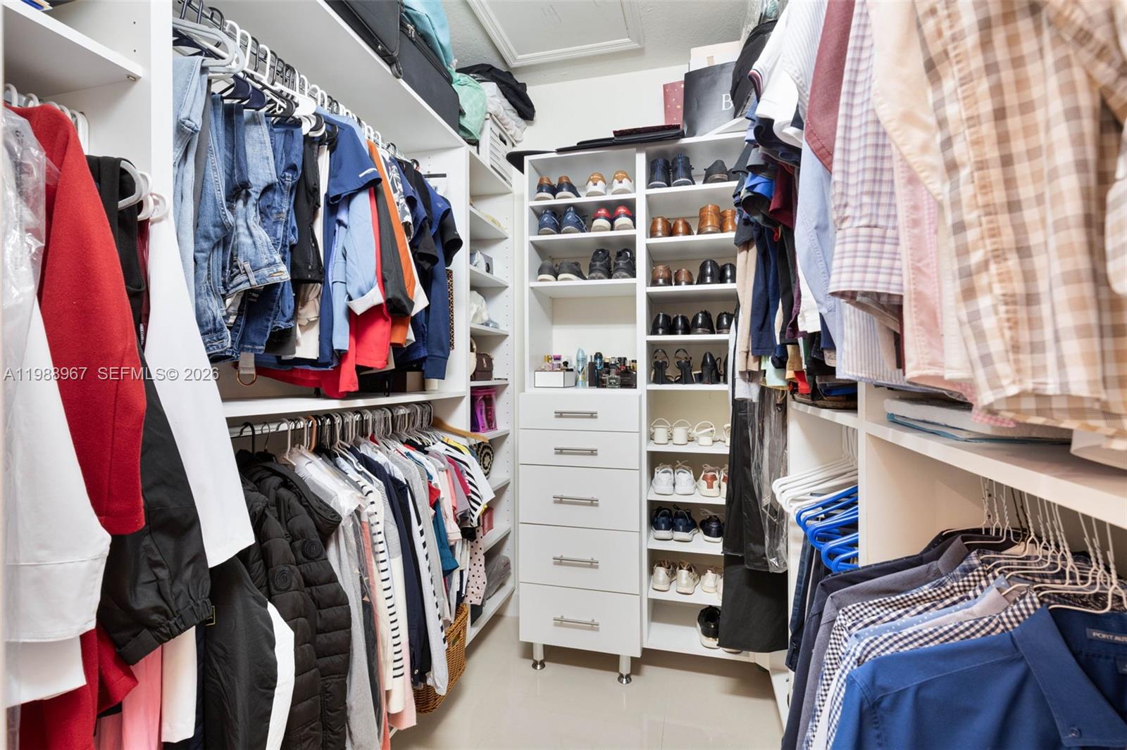 9015 Northwest 183rd Street Hialeah, FL 33018 - Photo 26 of 45 a view of walk in closet with clothes and shoes