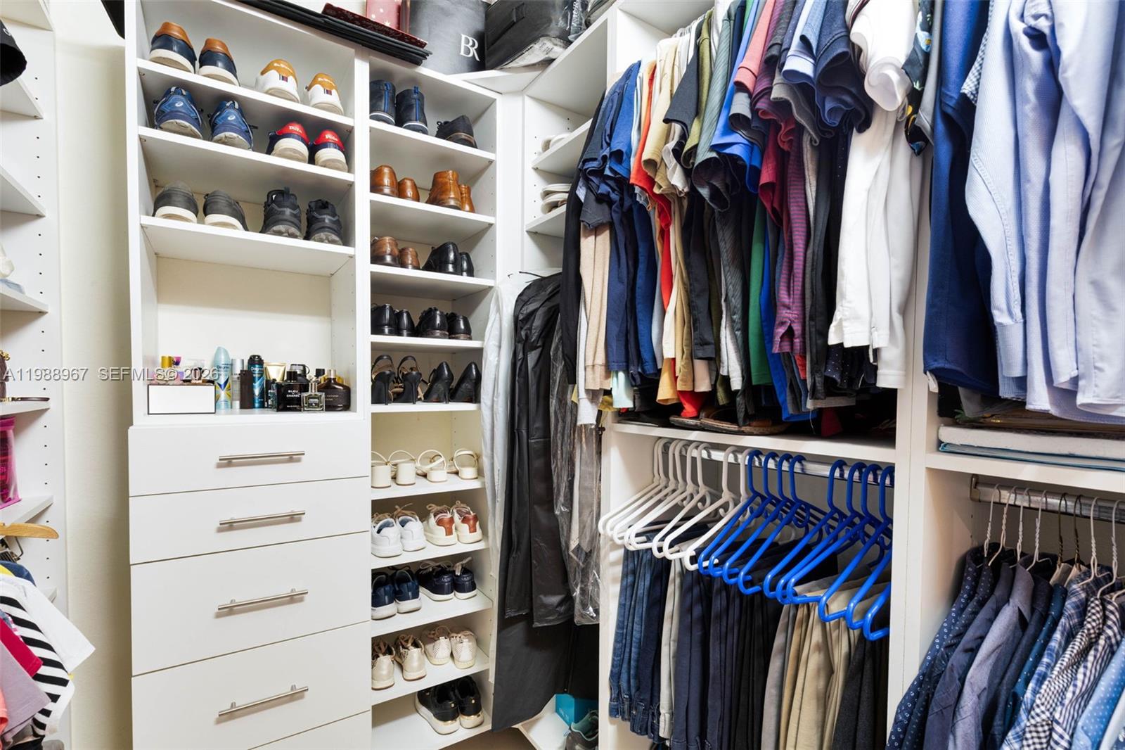9015 Northwest 183rd Street Hialeah, FL 33018 - Photo 27 of 45 a view of walk in closet with clothes and shoes