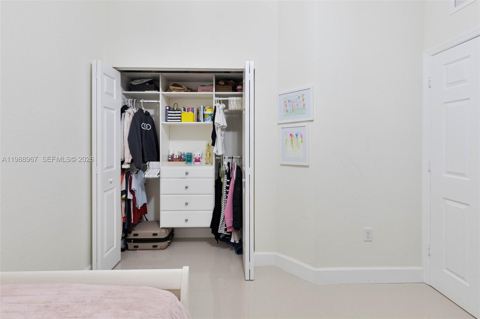 9015 Northwest 183rd Street Hialeah, FL 33018 - Photo 29 of 45 a view of walk in closet with clothes and shoes