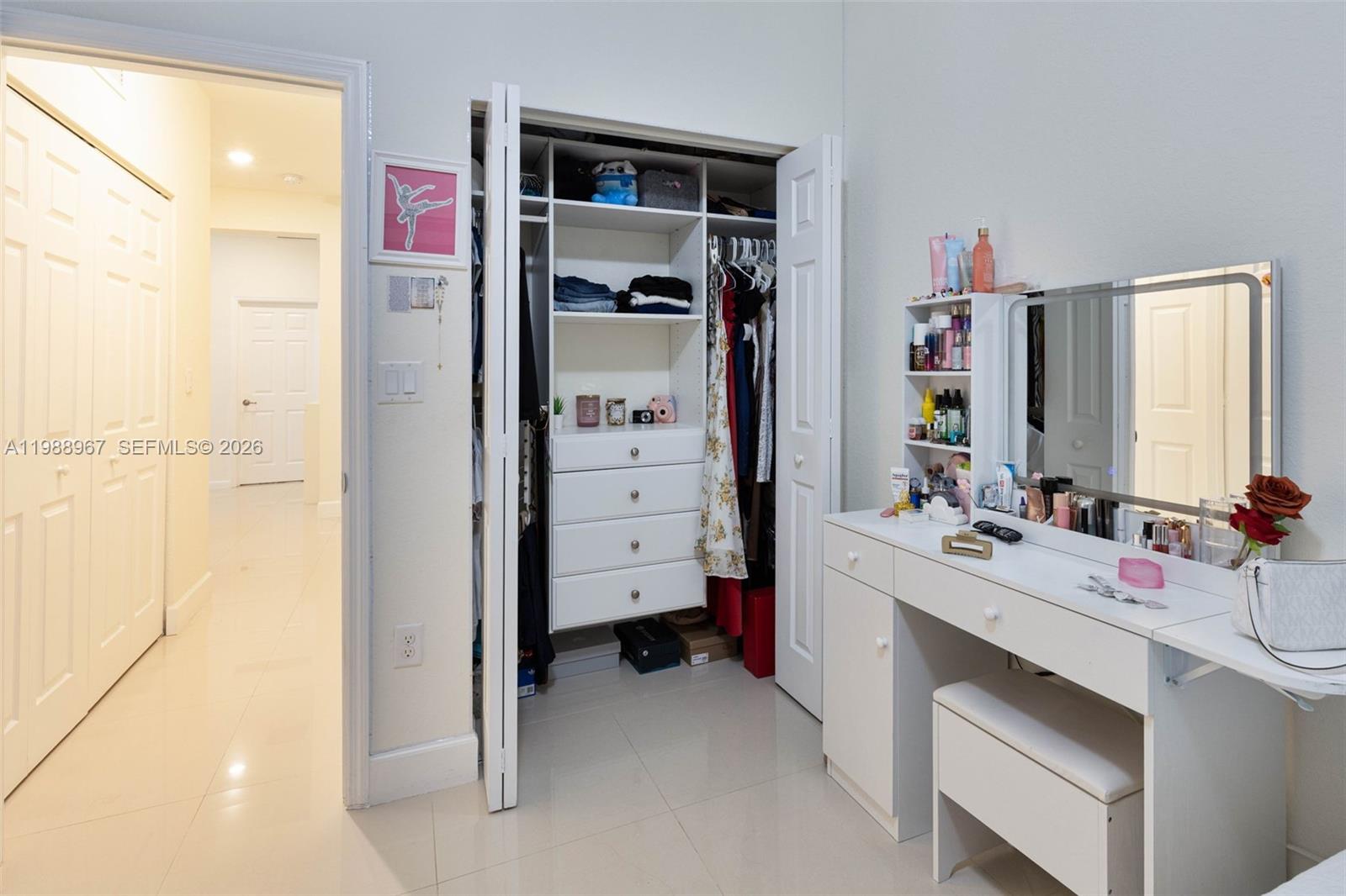 9015 Northwest 183rd Street Hialeah, FL 33018 - Photo 30 of 45 a view of walk in closet with clothes and shoes