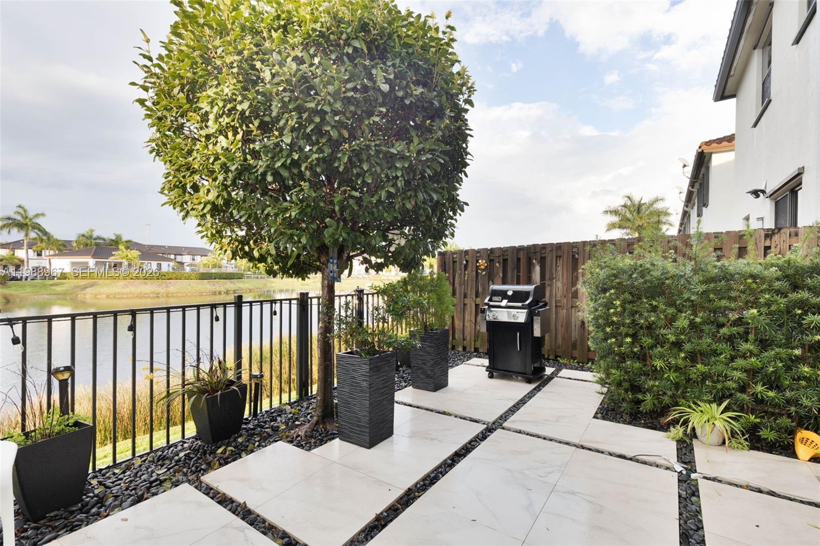 9015 Northwest 183rd Street Hialeah, FL 33018 - Photo 32 of 45 a balcony with wooden floor and fence