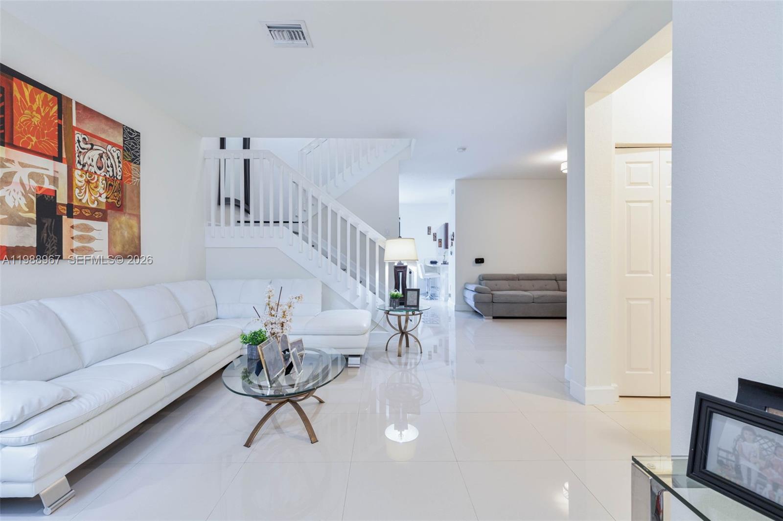 9015 Northwest 183rd Street Hialeah, FL 33018 - Photo 4 of 45 a living room with furniture and a flat screen tv