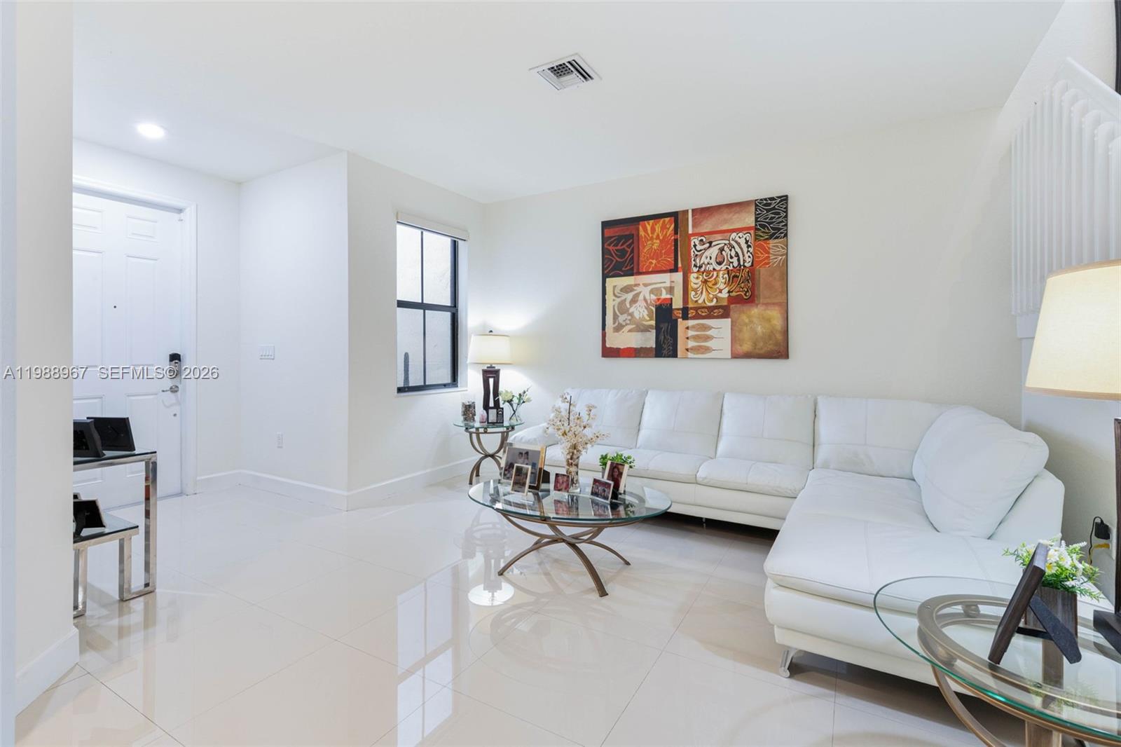 9015 Northwest 183rd Street Hialeah, FL 33018 - Photo 6 of 45 a living room with furniture and white walls