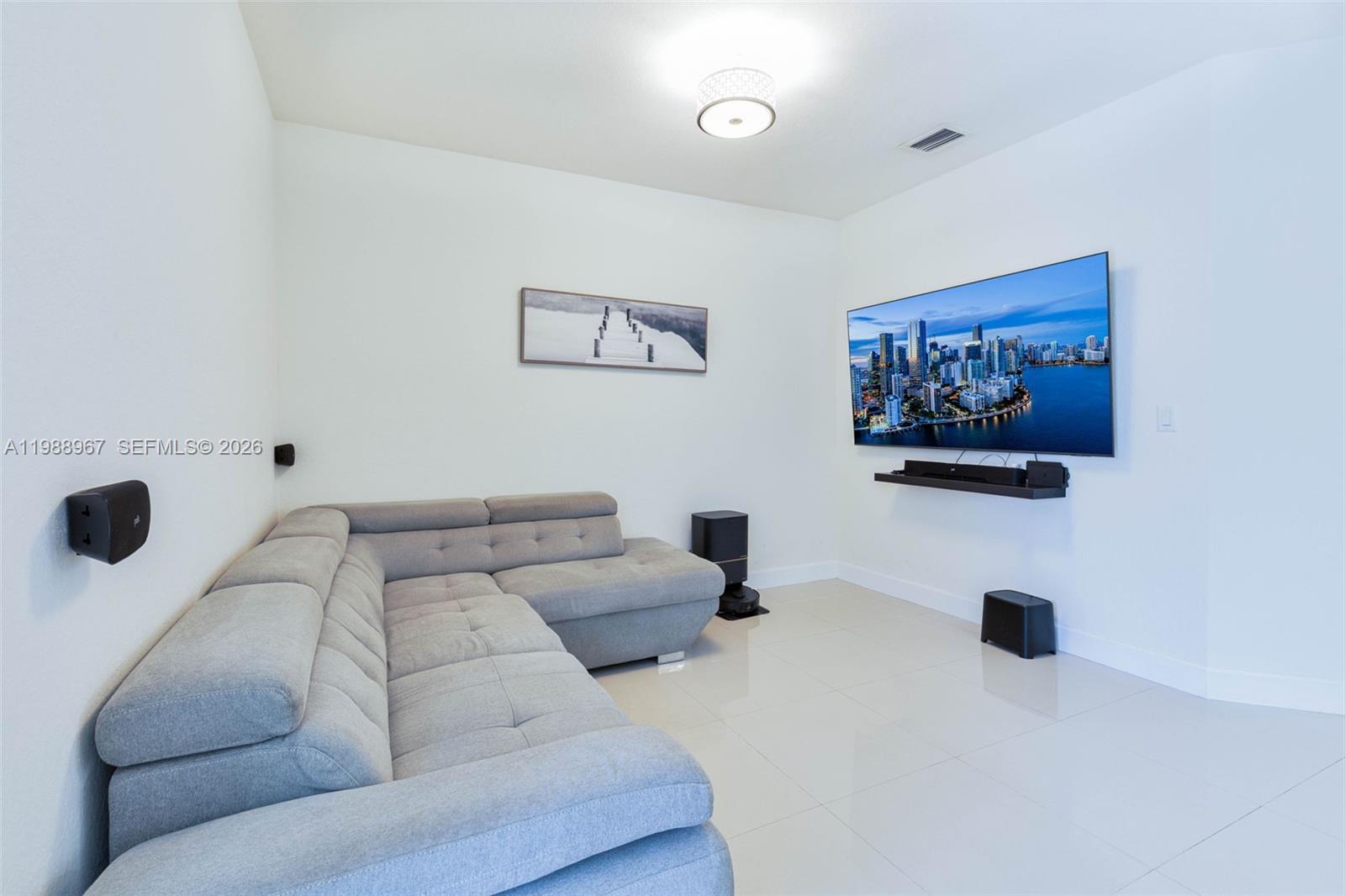 9015 Northwest 183rd Street Hialeah, FL 33018 - Photo 9 of 45 a living room with furniture and a flat screen tv