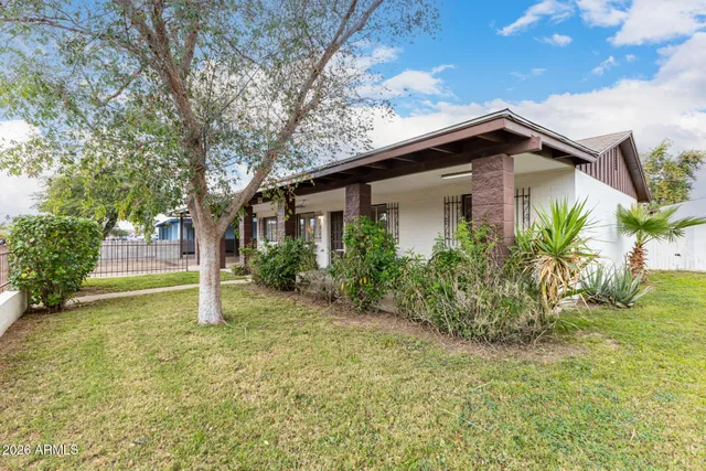 a house that has a tree in front of the house