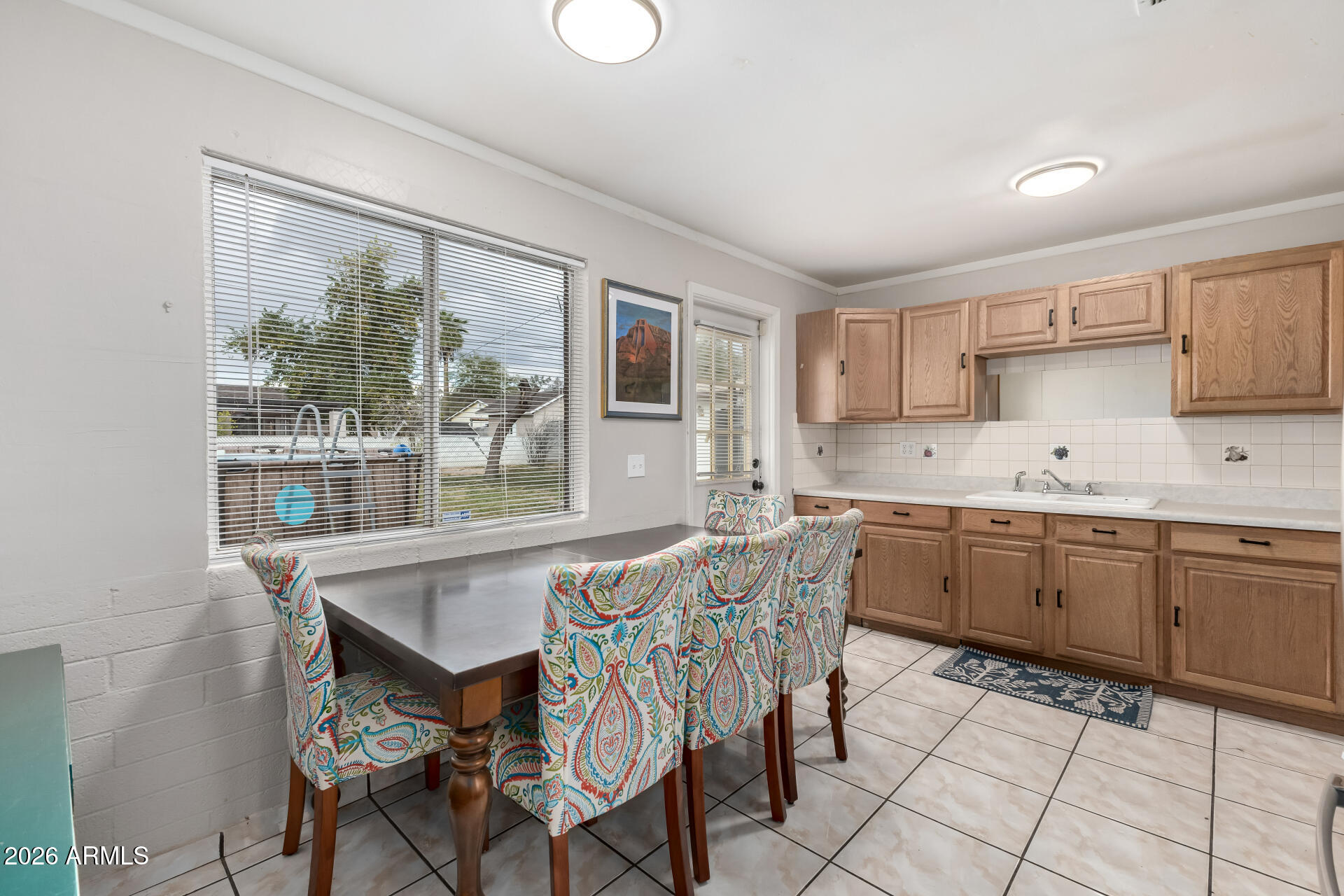 4032 West Nancy Lane Phoenix, AZ 85041 - Photo 12 of 29 a kitchen with granite countertop a table chairs stove and cabinets
