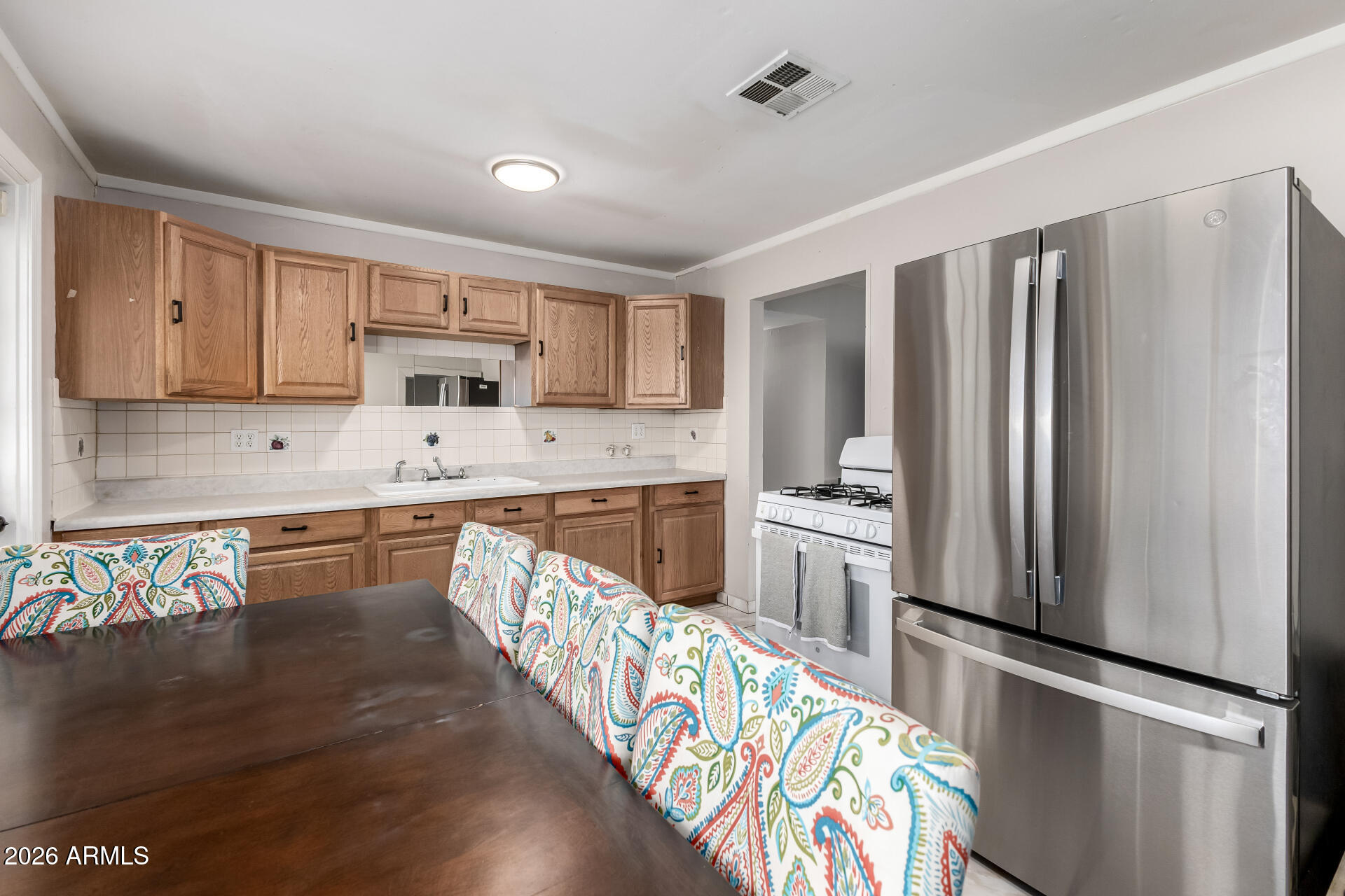 4032 West Nancy Lane Phoenix, AZ 85041 - Photo 13 of 29 a kitchen with stainless steel appliances granite countertop a refrigerator a stove a sink and dishwasher with wooden floor