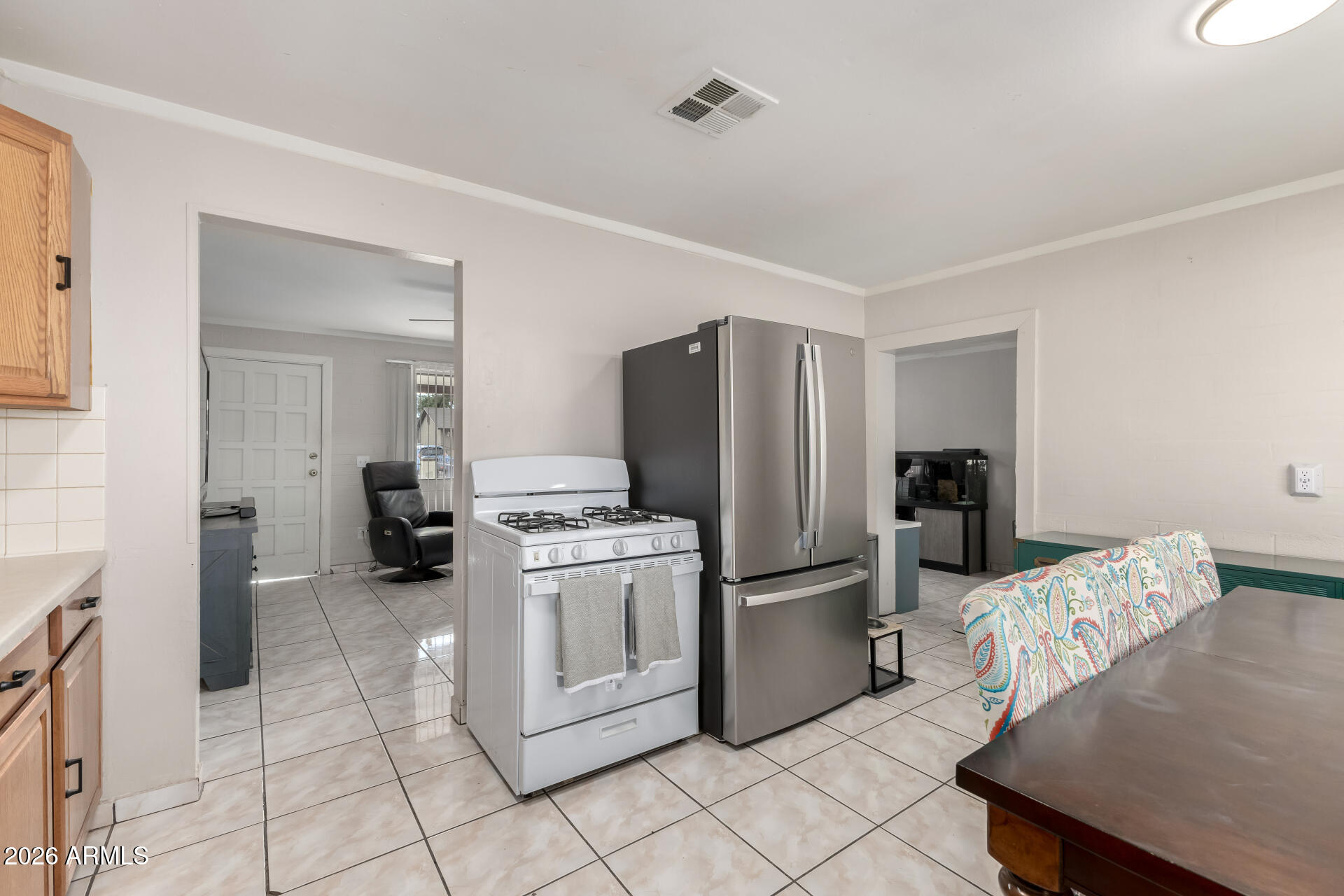 4032 West Nancy Lane Phoenix, AZ 85041 - Photo 14 of 29 a kitchen with stainless steel appliances a refrigerator and a stove top oven