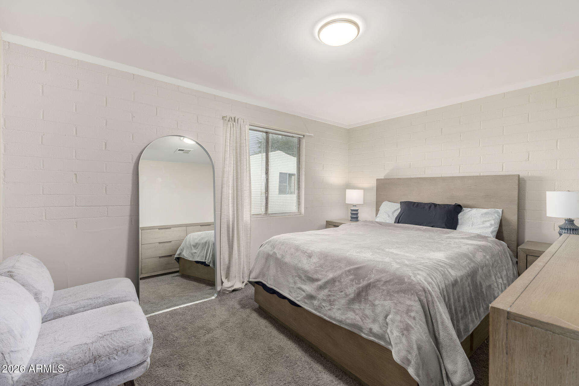 4032 West Nancy Lane Phoenix, AZ 85041 - Photo 16 of 29 a bedroom with a bed and a couch