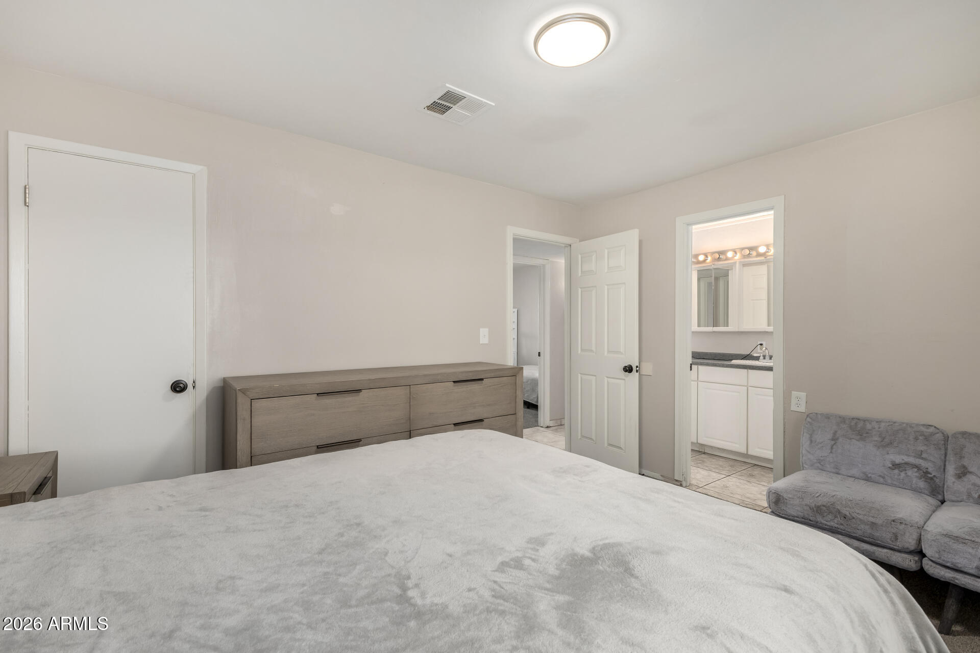 4032 West Nancy Lane Phoenix, AZ 85041 - Photo 17 of 29 a bedroom with a bed and a refrigerator