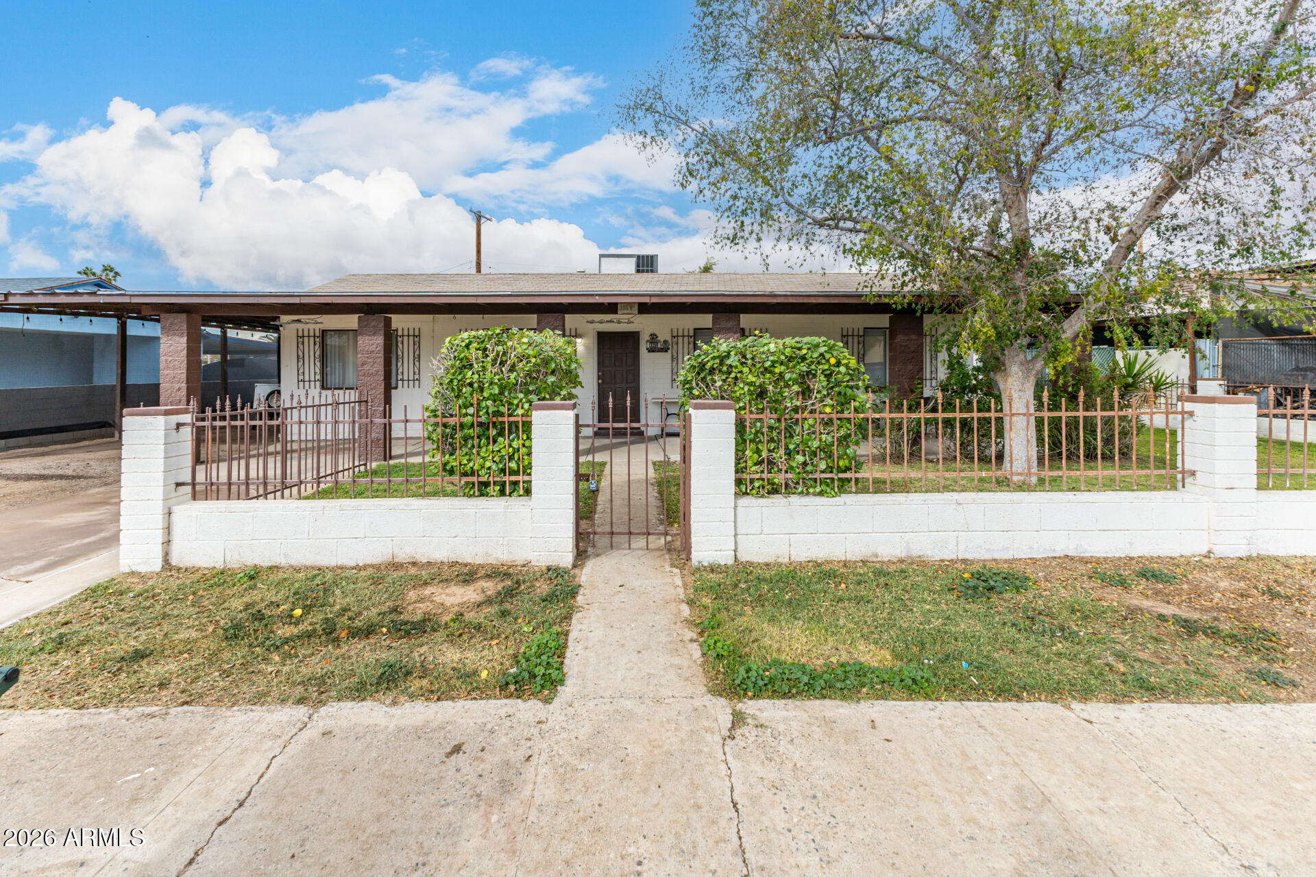 4032 West Nancy Lane Phoenix, AZ 85041 - Photo 2 of 29 a front view of a house with a yard