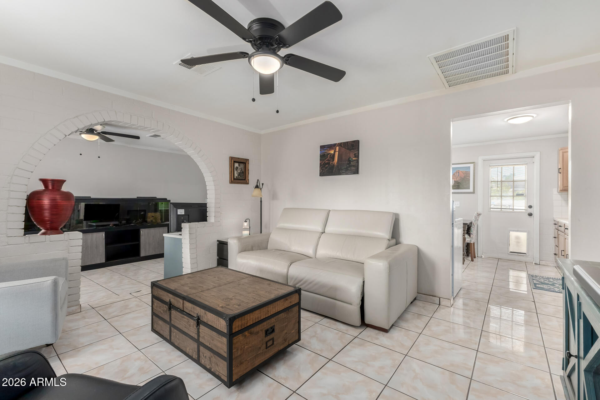 4032 West Nancy Lane Phoenix, AZ 85041 - Photo 7 of 29 a living room with furniture and a chandelier