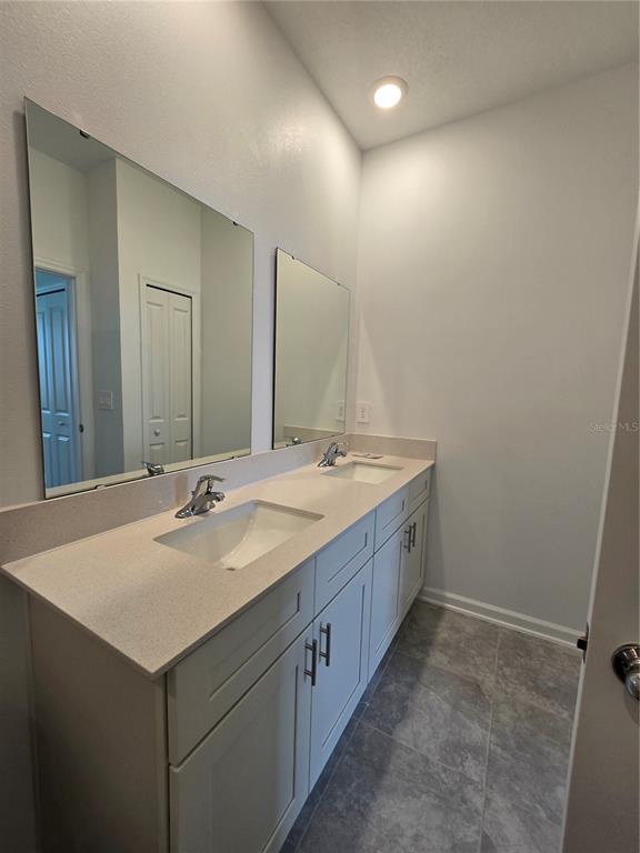 1767 Foreman Road Eagle Lake, FL 33839 - Photo 9 of 30 a bathroom with 2 sink and a mirror