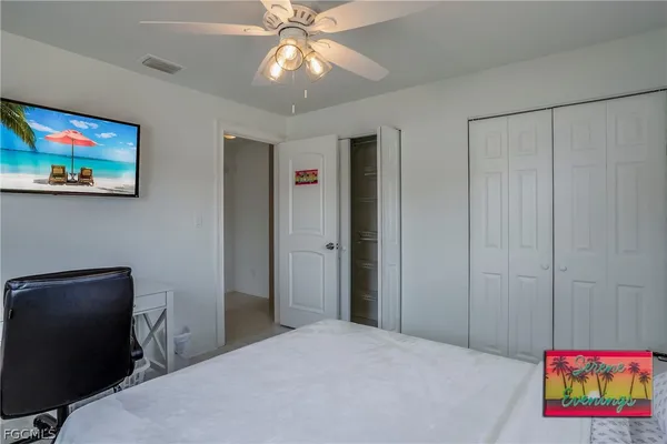 a bedroom with a bed and a bookshelf