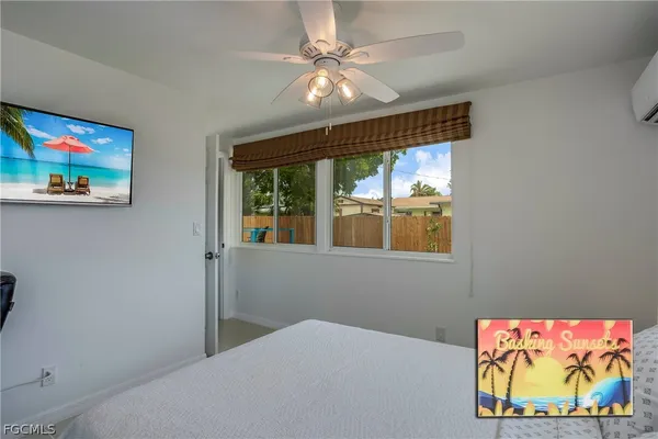 a bedroom with a bed and a painting on the wall