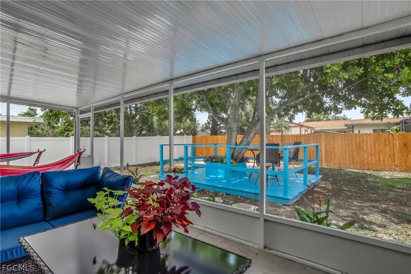 a living room filled with furniture and a potted plant