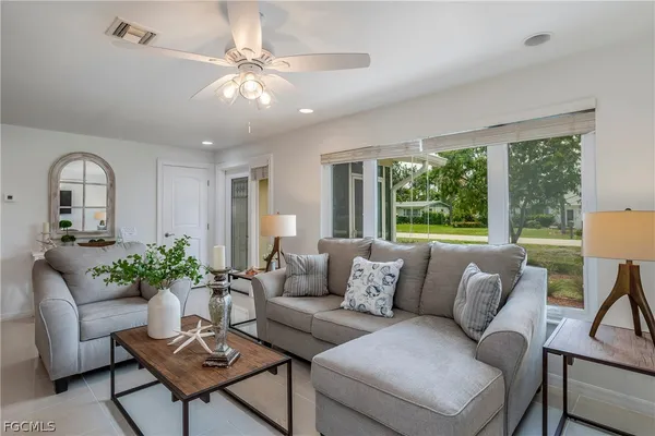 a living room with furniture and a large window