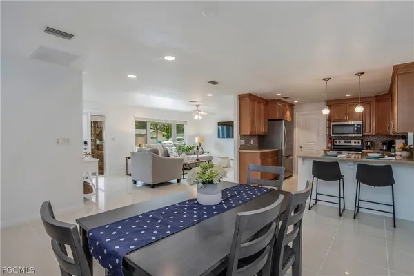 a kitchen with granite countertop kitchen island stainless steel appliances a table and chairs