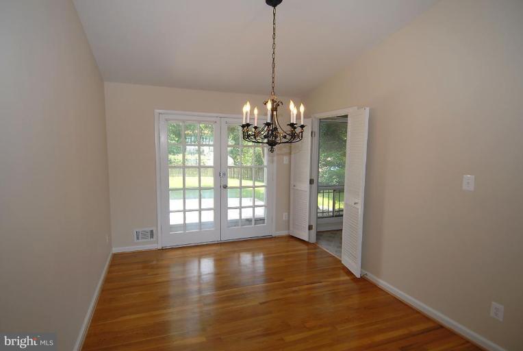 12801 Teaberry Road Silver Spring, MD 20906 - Photo 4 of 18 a view of a room with wooden floor and chandelier