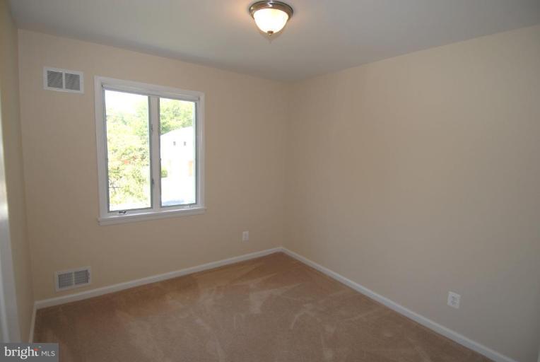 12801 Teaberry Road Silver Spring, MD 20906 - Photo 8 of 18 an empty room with a window