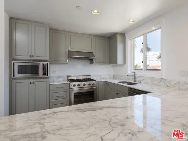 a kitchen with a sink stove and microwave