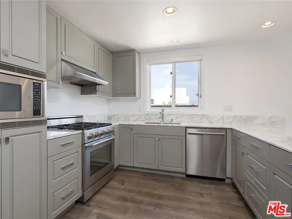 a bathroom with a granite countertop double vanity sink and mirror