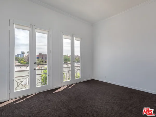 an empty room with wooden floor and closet