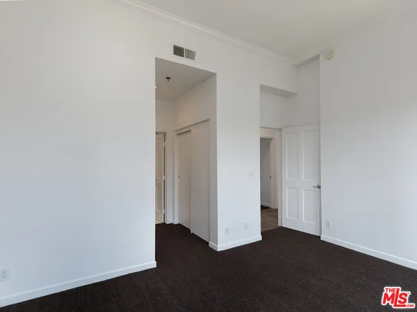 a bathroom with a toilet a sink a mirror and vanity