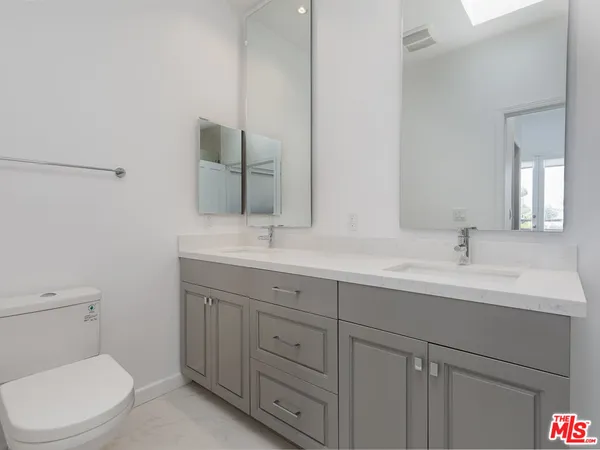 a bathroom with a sink a shower and a mirror
