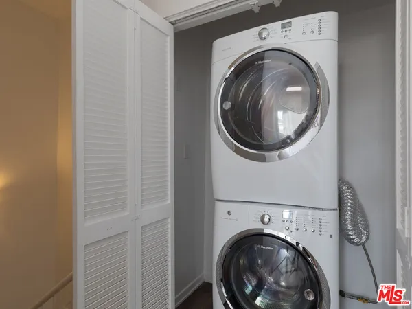 a view of a patio with wooden chairs