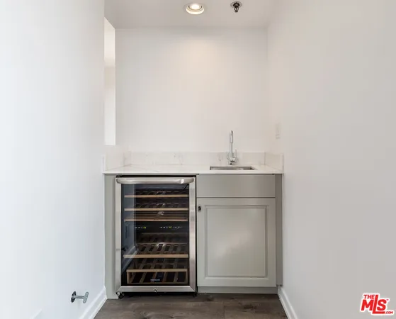 a view of empty room with wooden floor and fireplace