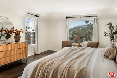 a bedroom with a bed and a mirror