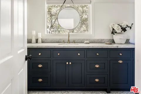 a bathroom with a granite countertop sink mirror and vanity