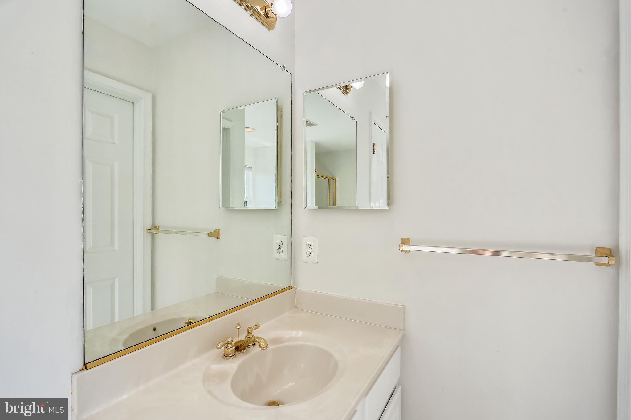 9517 Greenel Road Damascus, MD 20872 - Photo 56 of 98 a bathroom with a sink and a mirror