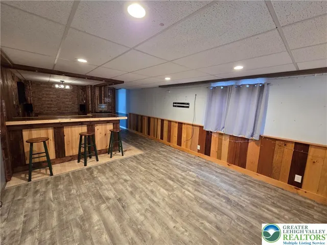 a kitchen with stainless steel appliances wooden cabinets dining table and chairs