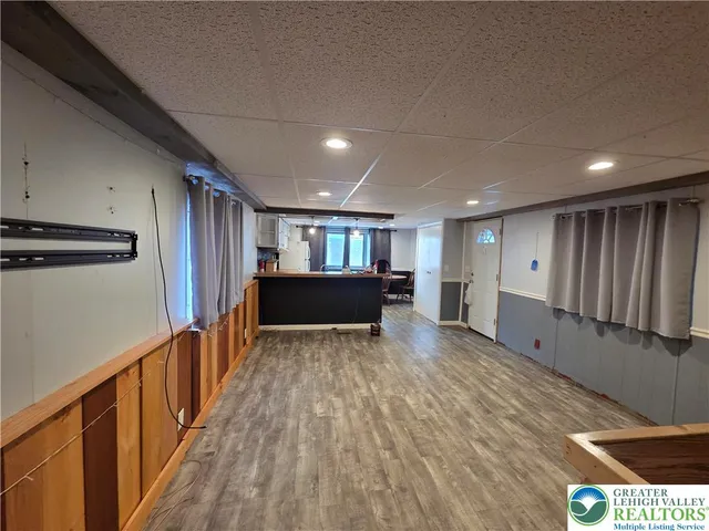 a kitchen with stainless steel appliances kitchen island granite countertop a sink and a refrigerator