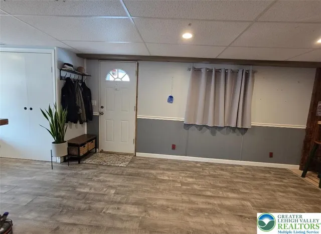 a living room with furniture a rug and kitchen view