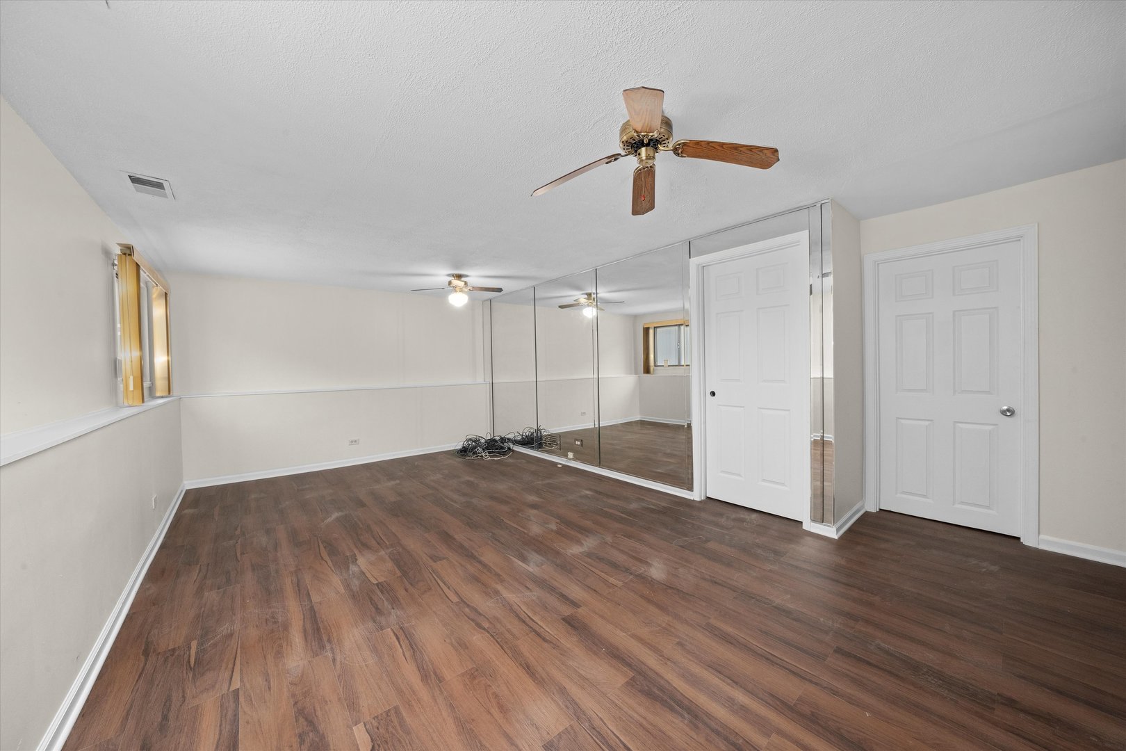 18057 Juneway Court Country Club Hills, IL 60478 - Photo 26 of 36 a view of empty room with wooden floor and ceiling fan