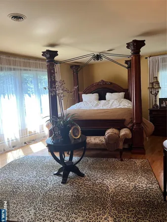 a bedroom with a bed a lamp and a window