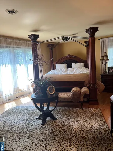 a bedroom with a bed a lamp and a window