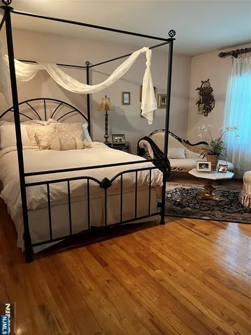 a bedroom with furniture and wooden floor