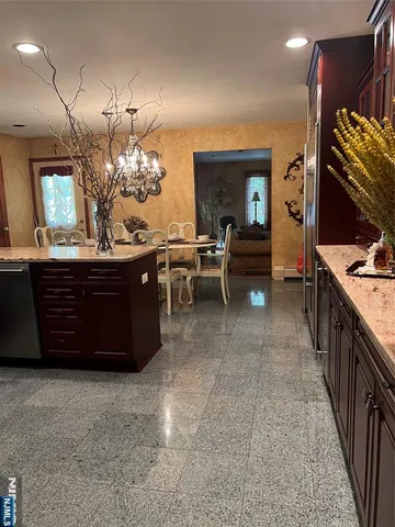 a kitchen with dining table and chairs